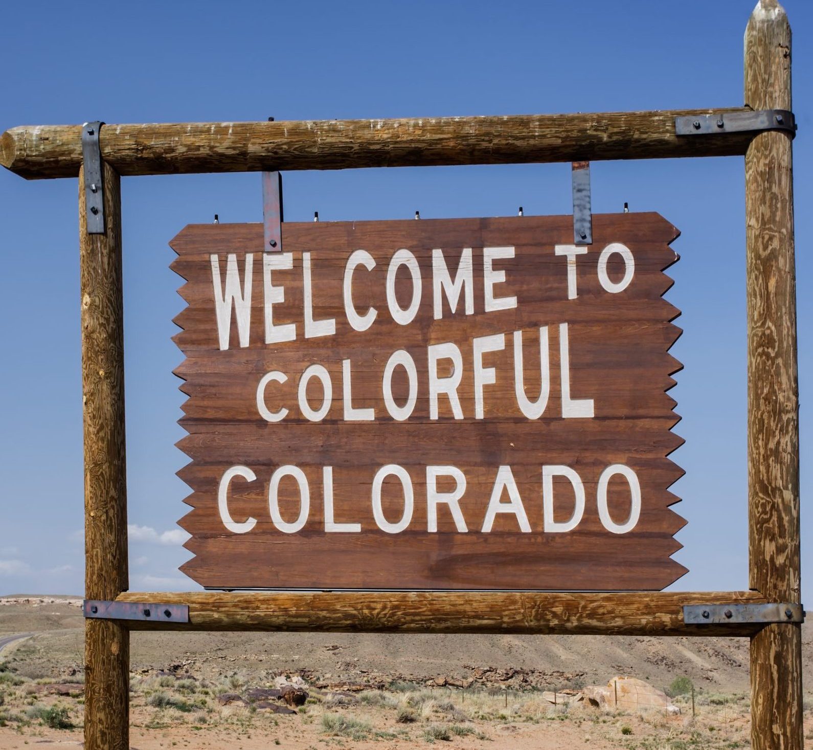 Colorado State Line road sign along a country road, USA colorful colorado welcome sign