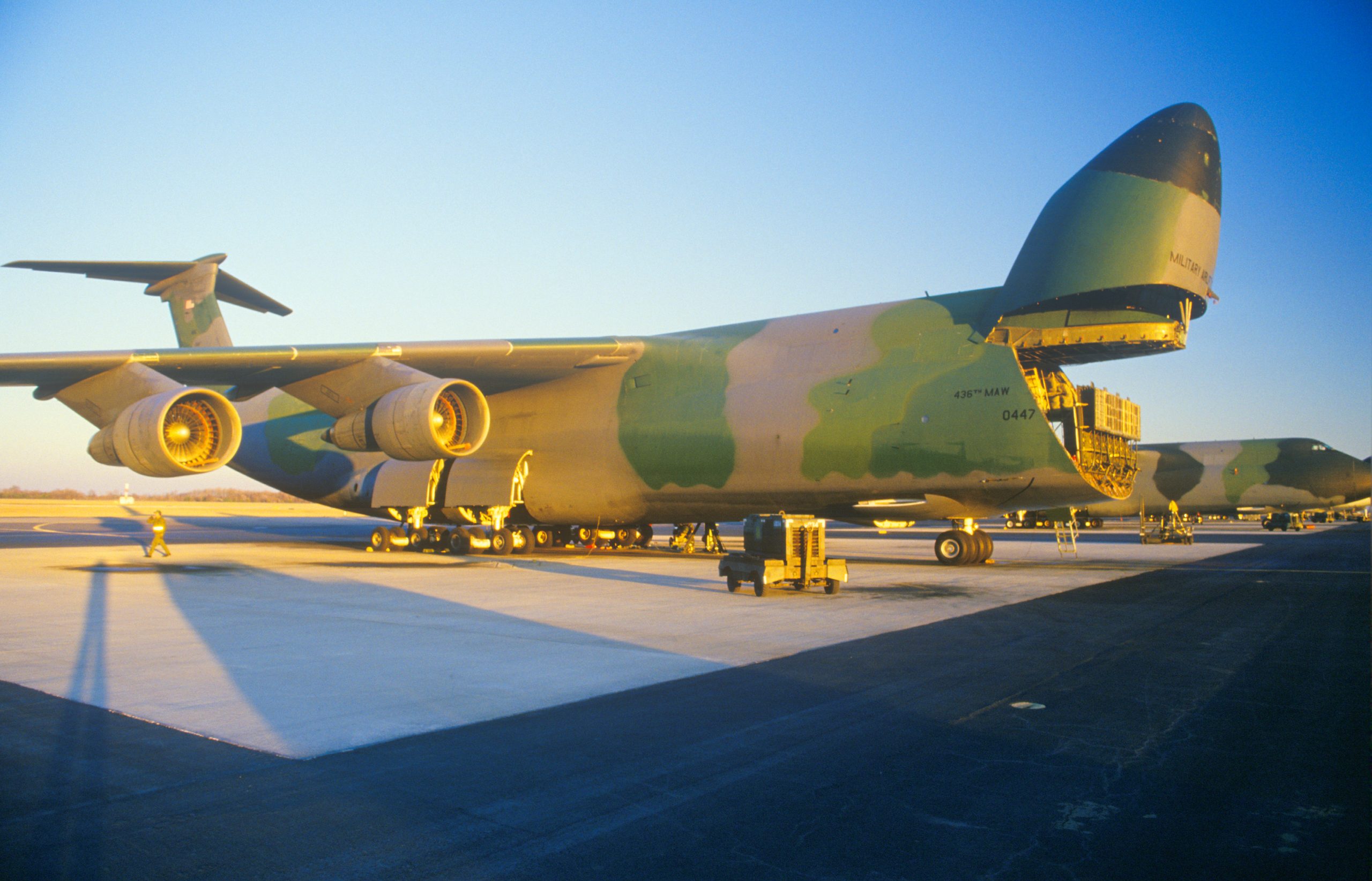 Cargo Plane at Dover Airforce Base, Sunset, Dover, Delaware. Drivers perspective on Delaware Memorial Bridge near Wilmington, DE, USA in northerly direction with cars on road crossing the Delaware River against a blue sky