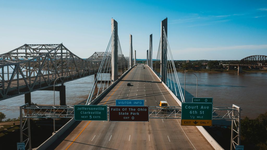 Bridge spanning a highway in Kentucky, with scenic landscapes in the background.
