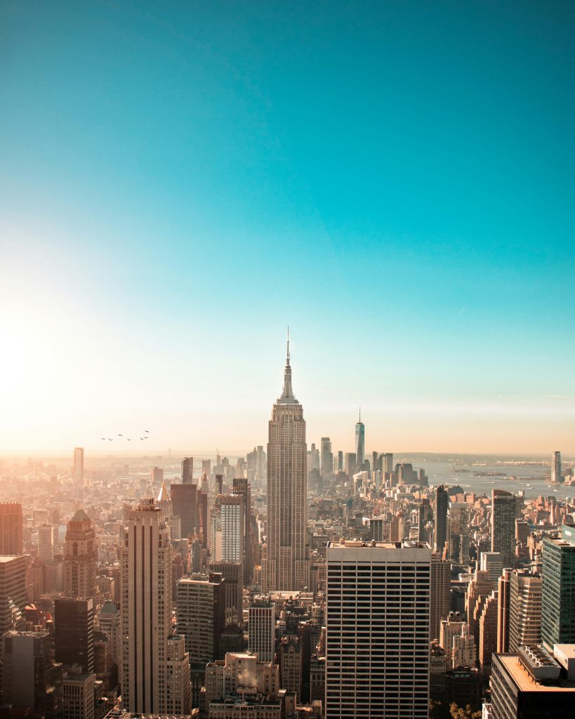 A stunning view of the New York City skyline, showcasing iconic skyscrapers and busy streets, highlighting the need for reliable car shipping services in and out of the city.