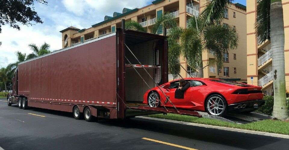 Enclosed car shipping options with red sports car on semi truck for transport.